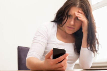 Upset Woman Reading A Text Message